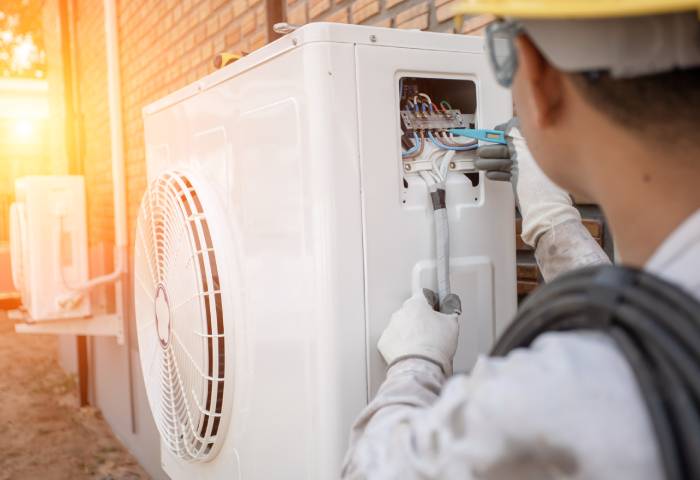 HVAC technician repairing a heat pump in Vancouver WA